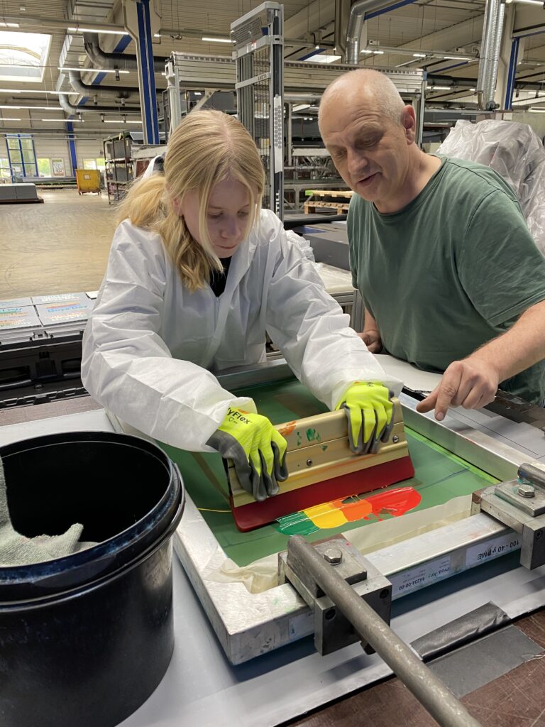 Mira tests her skills in the con-pearl screen printing process