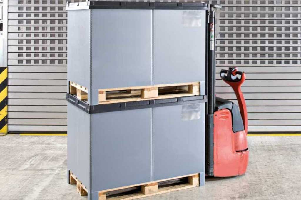 Zwei gestapelte Container auf Paletten auf Hochhubwagen