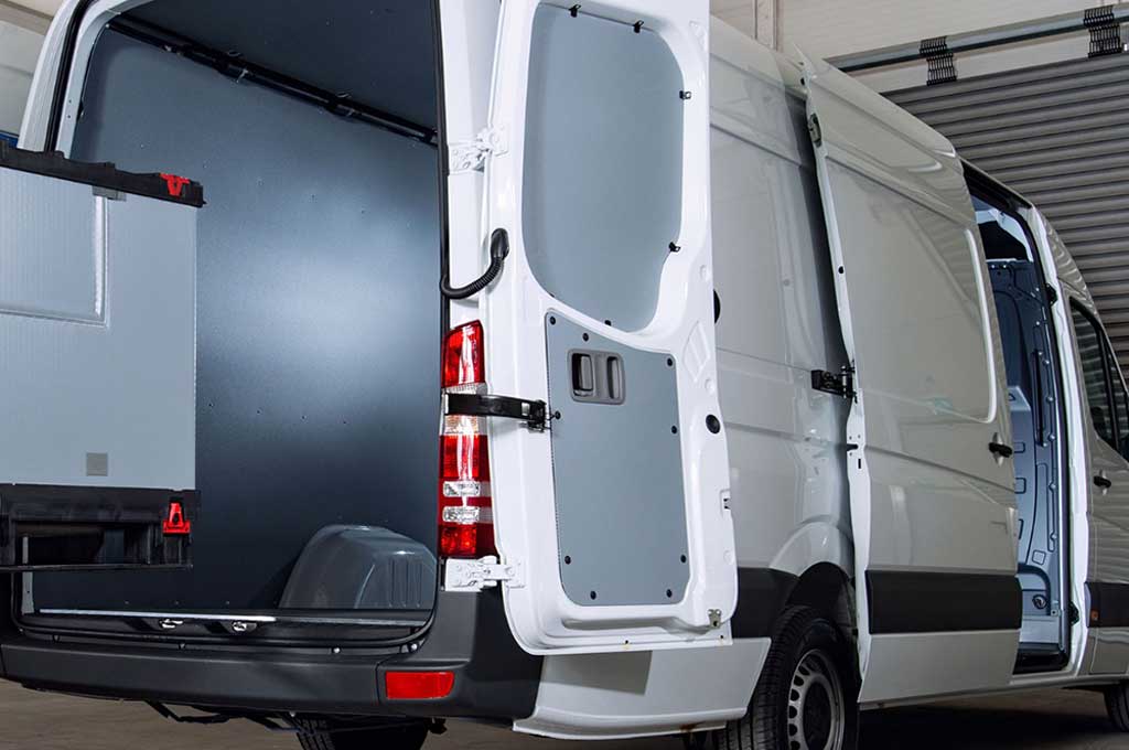 Transporter mit geöffneten Türen wird mit Container beladen